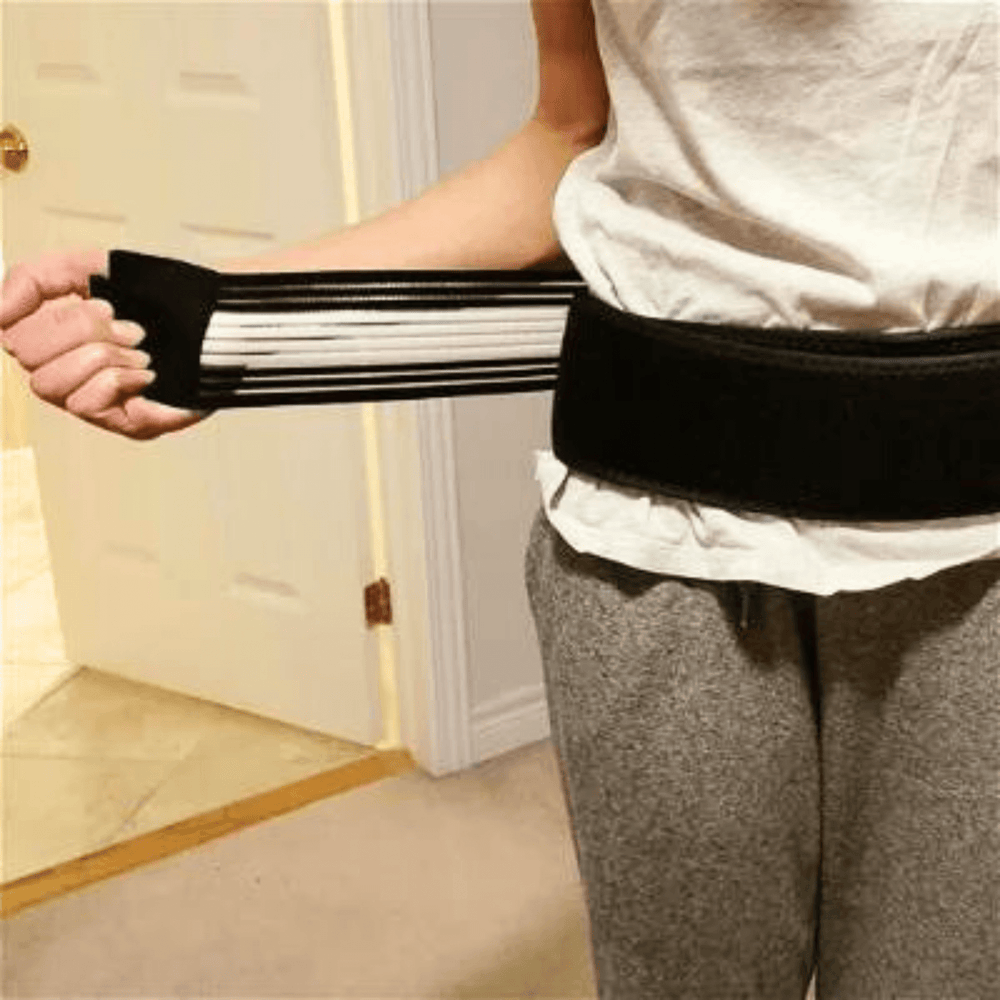Person wearing back support belt and arm brace