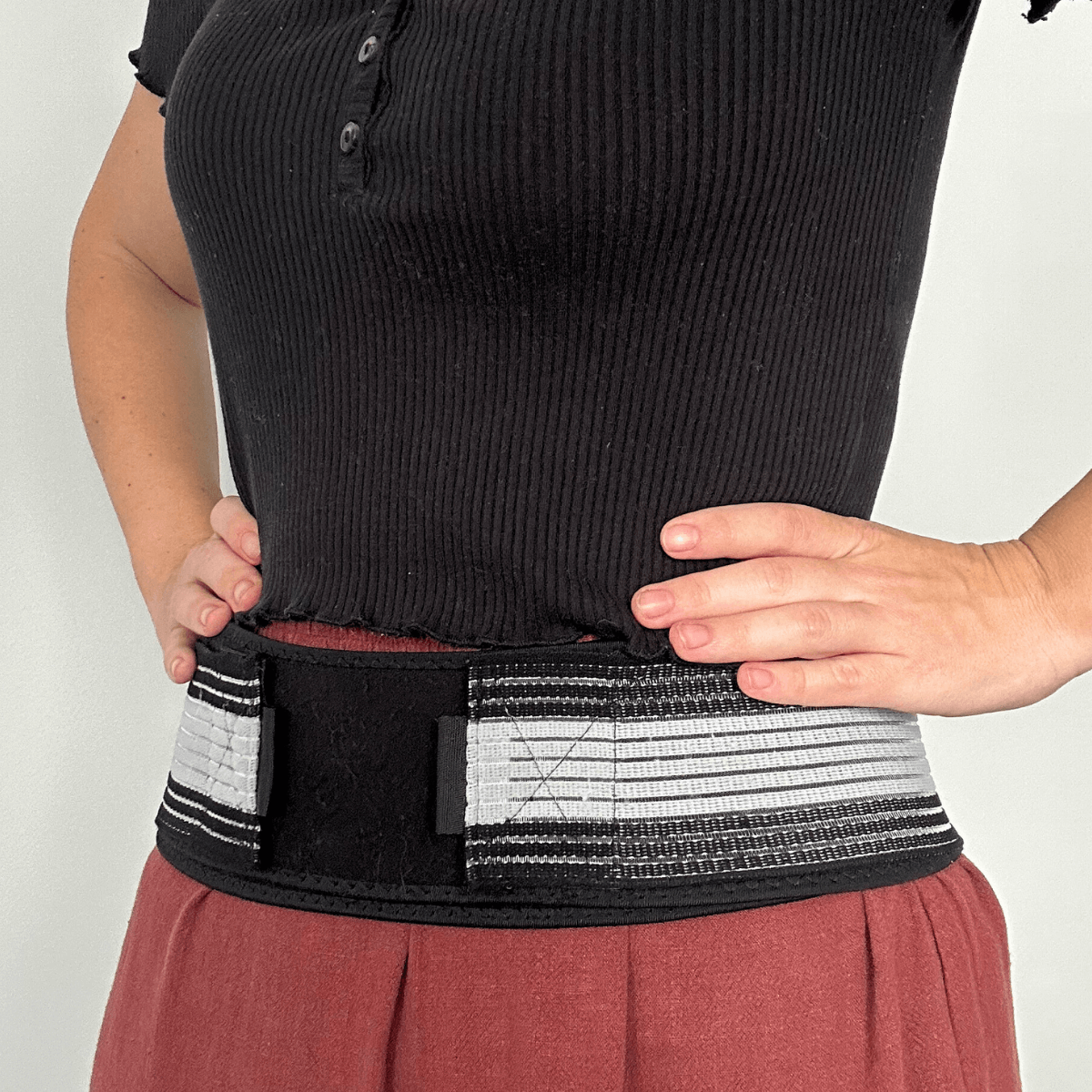 Woman wearing back support belt.